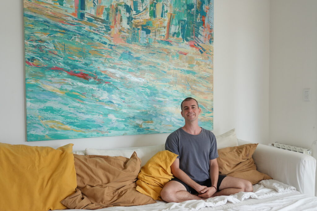 Person sitting peacefully on a couch, embodying calm and mindfulness for stress relief.