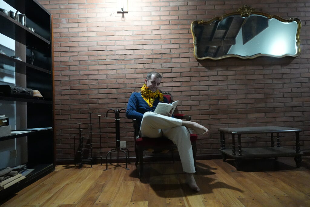 Man reading the Yoga Sutras of Patanjali, exploring ancient yoga philosophy and the Yamas and Niyamas for modern stress relief.