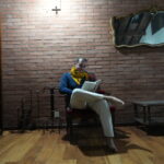 Man reading the Yoga Sutras of Patanjali, exploring ancient yoga philosophy and the Yamas and Niyamas for modern stress relief.